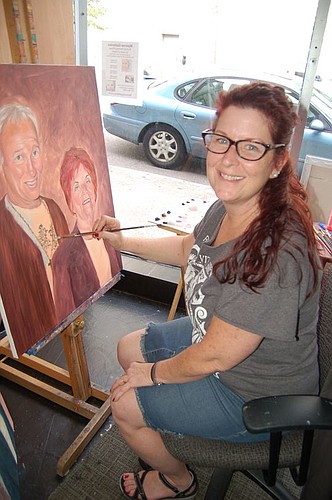 Jami Childers paints portraits next to the storefront display window at Monroe Galleries Downtown at 40 W. Monroe St. Being able to work where pedestrians can walk by and watch her paint is one of the reasons she leased the space, but there's not enou...