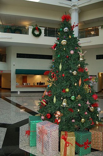 The holiday atmosphere began Downtown on Thursday morning when City Hall was decorated from the floor to the ceiling, including a Christmas tree in the atrium. The center of local government's annual open house and holiday celebration is 5-9 p.m. Dec....