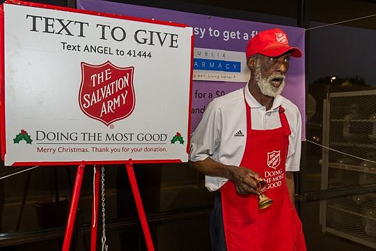 Harold Pierce sings "Yesterday" while he rings the bells for The Salvation Army of Northeast Florida kettle campaign outside the Publix Super Markets store at Townsend and Merrill roads. After Thanksgiving, Pierce will be singing Christmas carols, inc...