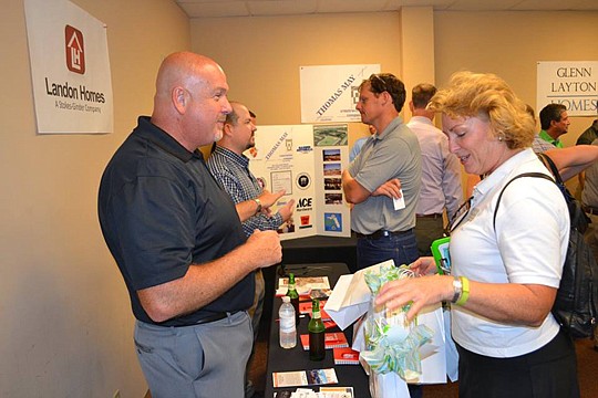 David Bell of Landon Homes and Peggy Collins with Polished Properties engage in a one-on-one discussion, which is the goal of the Meet the Builder evening.