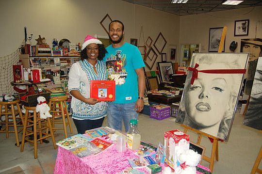 Elonya and Adrian Pickett at AP Studios and New2U Booknuk at the Jacksonville Landing. The couple leased a space at the Landing to accommodate his artwork and her book collection.