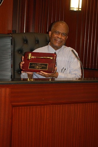 Retiring 4th Judicial Circuit Judge Henry Davis received a plaque from the D.W. Perkins Bar Association.