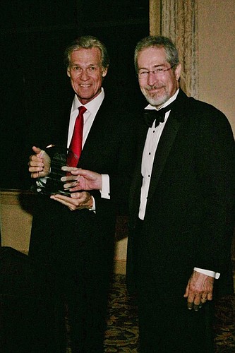 Attorney Wayne Hogan presents Jurist of the Year honors to Lester.