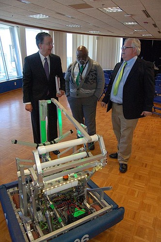 From left, JEA CEO Paul McElroy and JEA engineers Jacob Plicque and Todd Lovelace with a robot designed and fabricated by JEA Team Resistance.