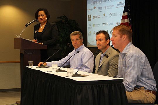 Jason Sessions, right, of Mattamy Homes answers a question during the Northeast Florida Builders Association Sales &amp; Marketing Council breakfast. Also pictured are Katrina Watkins, of Glenn Layton Homes, who moderated the discussion on "hidden tre...