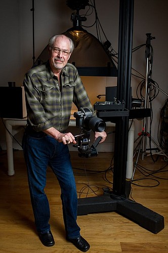 Daryl Bunn in his Brooklyn studio with his camera. Behind him is the table-top set-up he uses to create his food and product photography.