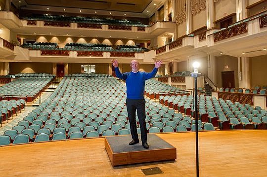 Peter Gladstone, vice president of marketing for the Jacksonville Symphony, stands on the conductor's rostrum on the stage in the concert hall at the Times-Union Center for the Performing Arts, for which he orchestrates the filling of the 1,800 seats.