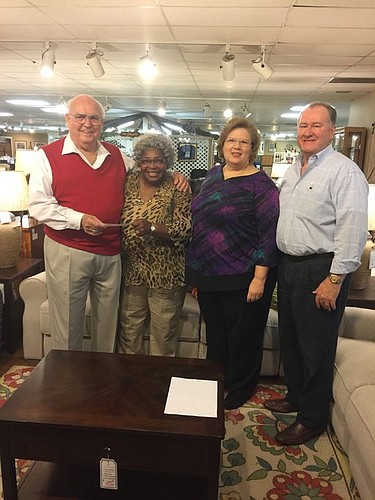 Orange Park Furniture donated $56,500 to Clay County Habitat for Humanity to build a new home for a partner family member.Â From left are Elmer (E.J.) James, owner of Orange Park Furniture; Carolyn Edwards, executive director of Clay County Habitat fo...