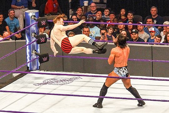 Jack Gallagher hits Tony Nese with a high-flying drop kick Tuesday at World Wrestling Entertainment's Smackdown Live! at Veterans Memorial Arena.