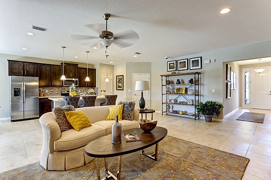 Seda New Homes' Crestview D model features a large gathering room that is open to the kitchen and has access to the lanai.