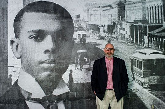 Cultural Council of Greater Jacksonville executive director Tony Allegretti stands in his office in the Times-Union Center in front of the wall-to-ceiling photographic mural of James Weldon Johnson created for him by local artist Matt Abercrombie.