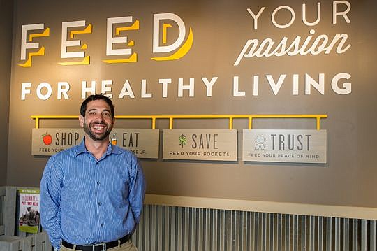 Aaron Gottlieb, founder of Native Sun Natural Foods Market, stands by a graphic in the Jacksonville Beach store that spells out the company's mantra when it comes to healthy living. Gottlieb has an all-consuming desire to educate consumers about their...