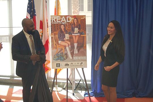 Ronnie King, chair of the Jacksonville Public Library Board of Trustees, and Jacksonville Jaguars Roar cheerleader Alison Powers unveiled the poster for the annual "Jax Reads" Wednesday at the Main Library Downtown. Powers, who is from Taiwan, and Roa...