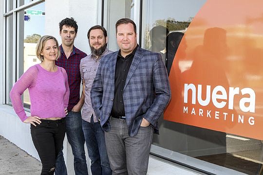 Meredith O'Malley Johnson, Jack DeYoung, Grant Nielsen and Joe Sampson outside the Nuera Marketing office at 1807 Hendricks Ave. Sampson and Nielsen are partners in the agency.