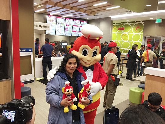 Helen De Nardis with the Jollibee mascot. De Nardis and her daughter, son and grandson were the first Jacksonville customers, setting up in line at 2 a.m. Saturday in advance of the 7 a.m. opening.