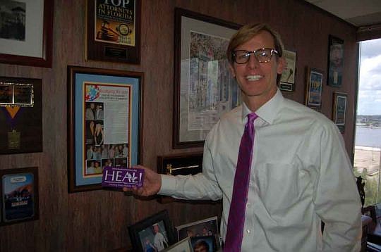 Attorney Alan Pickert keeps a supply of magnets in his office that are printed with contact information for Healing Every Autistic Life, a local nonprofit he has been advocating for since it was established in 2007. "They're conversation-starters. I a...