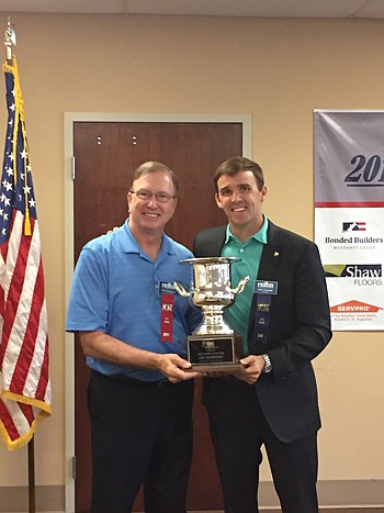 Lee Arsenault, left, was installed as president of the Northeast Florida Builders Association for 2017. At right is Chet Skinner, outgoing president for 2016, who recently presented Arsenault the Florida Home Builders Association's Builder of the Year...