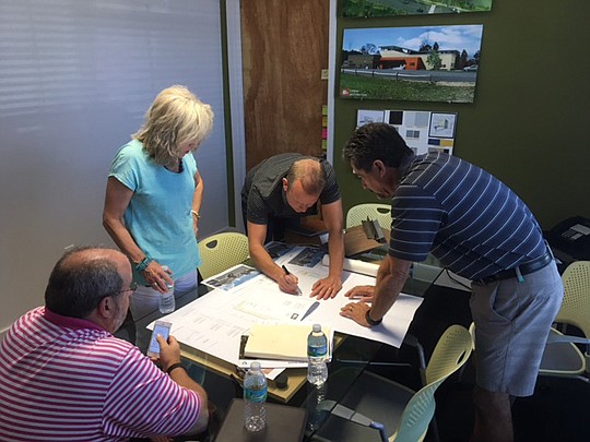 Architect Erik Kasper meets with Rick Morales, 2015 NEFBA president; Barbara Moore, 2012 president; and Building Committee Chair Glenn Layton, 2009 president, to discuss plans to build a 10,000-square-foot building to house NEFBA offices.