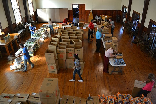 St. Mary's Episcopal Church was the scene of activity as food was delivered, sorted and baskets prepared for distribution.
