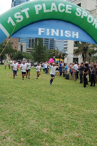 Gunster attorney Michael Freed crosses the finish line after his 157-mile, six-day run that began May 28 at the state Supreme Court in Tallahassee and ended about 4 p.m. Friday at the Duval County Courthouse.