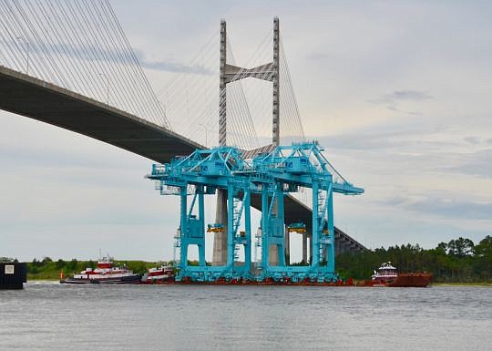 Two large container cranes traveled under the Dames Point Bridge on Sunday.