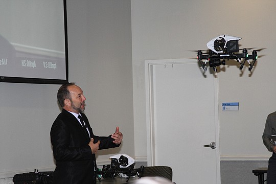 Emmy Award-winning videographer Dan Foard flies one of his drones around the Northeast Florida Association of Realtors' auditorium classroom last month.
