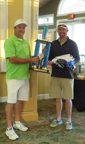 Mike Greene and Jason Herndon hold the first-place trophy awarded to the Greene Quality Construction team which also included Donnie Thomas and Tanner Tipton.