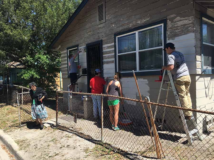 Lucille Sheppard leaves her home during the Builders Care painting project with a smile and the assurance that a new paint job will meet the requirements of her home insurance company.