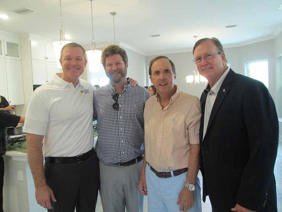 Attending the "Homes from the Heart" grand opening: Sean Junker, president and chief operating officer of Providence Homes; Justin Brown, director of Builders Care; Bill Cellar, CEO of Providence Homes; and Lee Arsenault, New Leaf Construction and NEF...