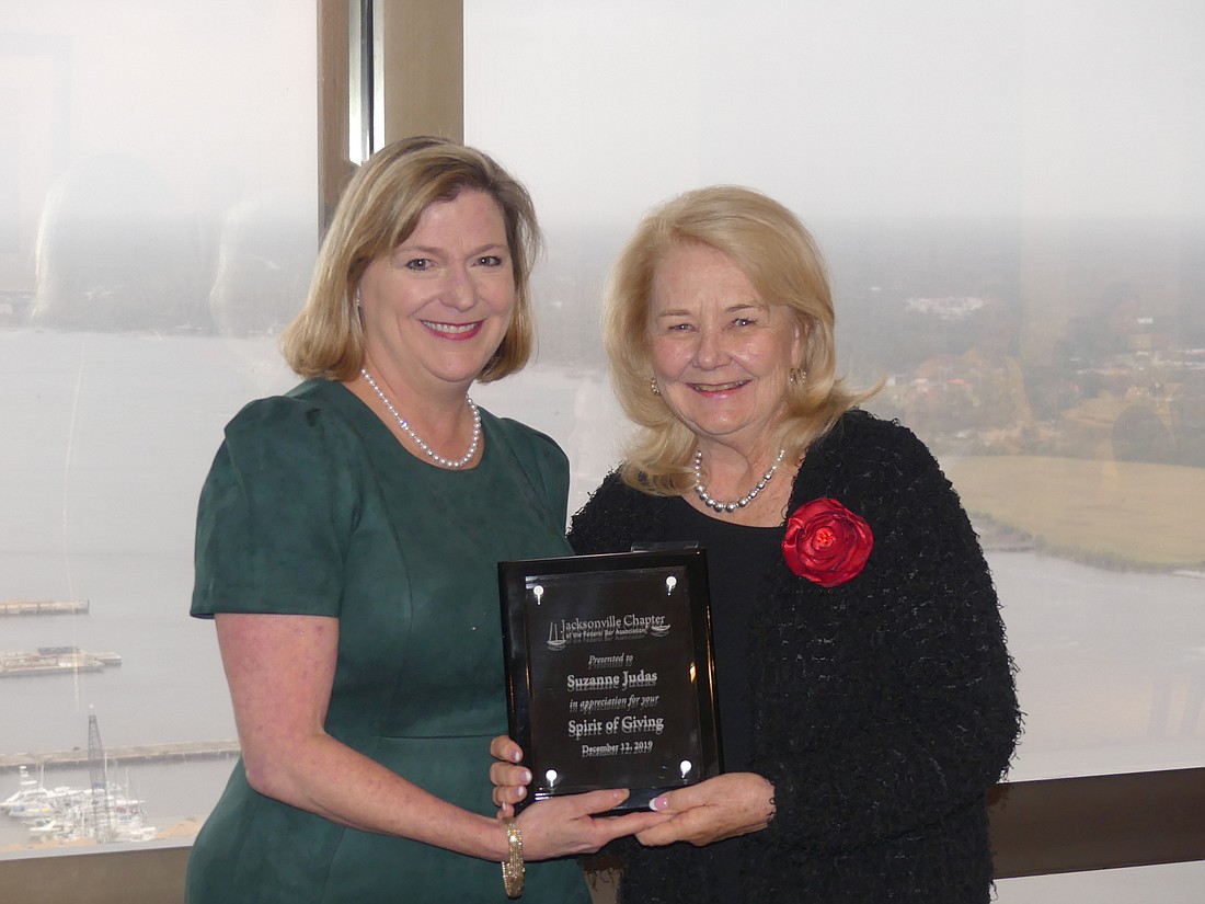 U.S. District Judge Marcia Morales Howard, left, presented the Spirit of Giving Award to Suzanne Judas, the U.S. District Court Jacksonville Division community outreach coordinator.