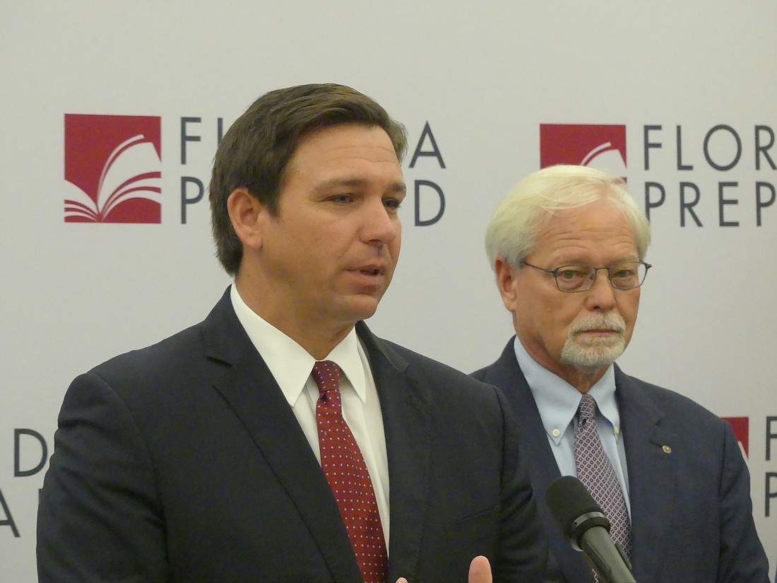 Gov. Ron DeSantis, left, and John Rood, chair of the Florida Prepaid College Board, announced Jan. 13 that the price of the state&#39;s prepaid college tuition plans is being reduced for current enrollees by $1.3 billion.