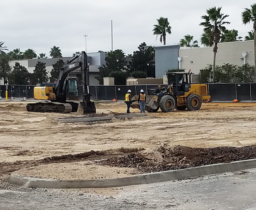 Workers and equipment at St. Johns Town Center on Jan. 30 in the former parking area behind the Apple store and Tesla.