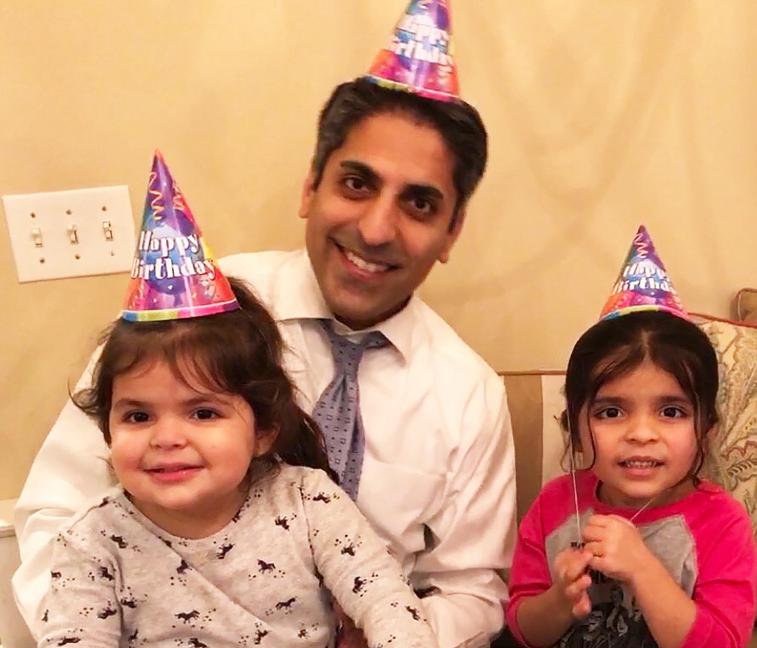 Fraz Ahmed, Lindsay Tygartâ€™s husband, with their daughters, Silas, left, and Salem at the familyâ€™s 19th Amendment party.