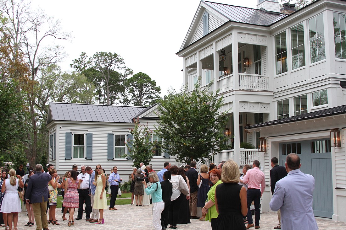 Guests gather outside the 2019 Southern Living Idea House on Crane Island for its grand-opening celebration in June. The property at 50 Cord Grass Court in Fernandina Beach sold Jan. 22 for $3.55 million. (Photo by Maggie FitzRoy)