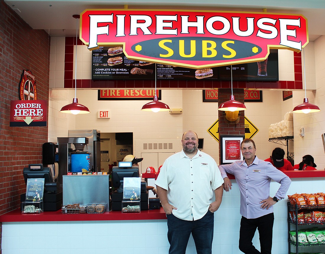 Brothers Robin and Chris Sorensen, co-founders of Firehouse Subs, stand at the restaurantâ€™s first airport location at Jacksonville International Airport.