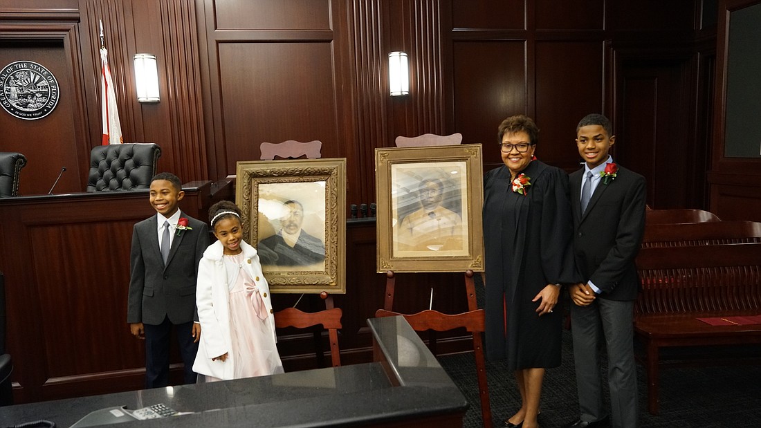 At Duval County Judge Pauline Drakeâ€™s retirement ceremony, she showed portraits of her great-grandparents.  Her grandchildren, from left, Jeremiah Desir, Selah Grace Desir and Michael Desir watch.