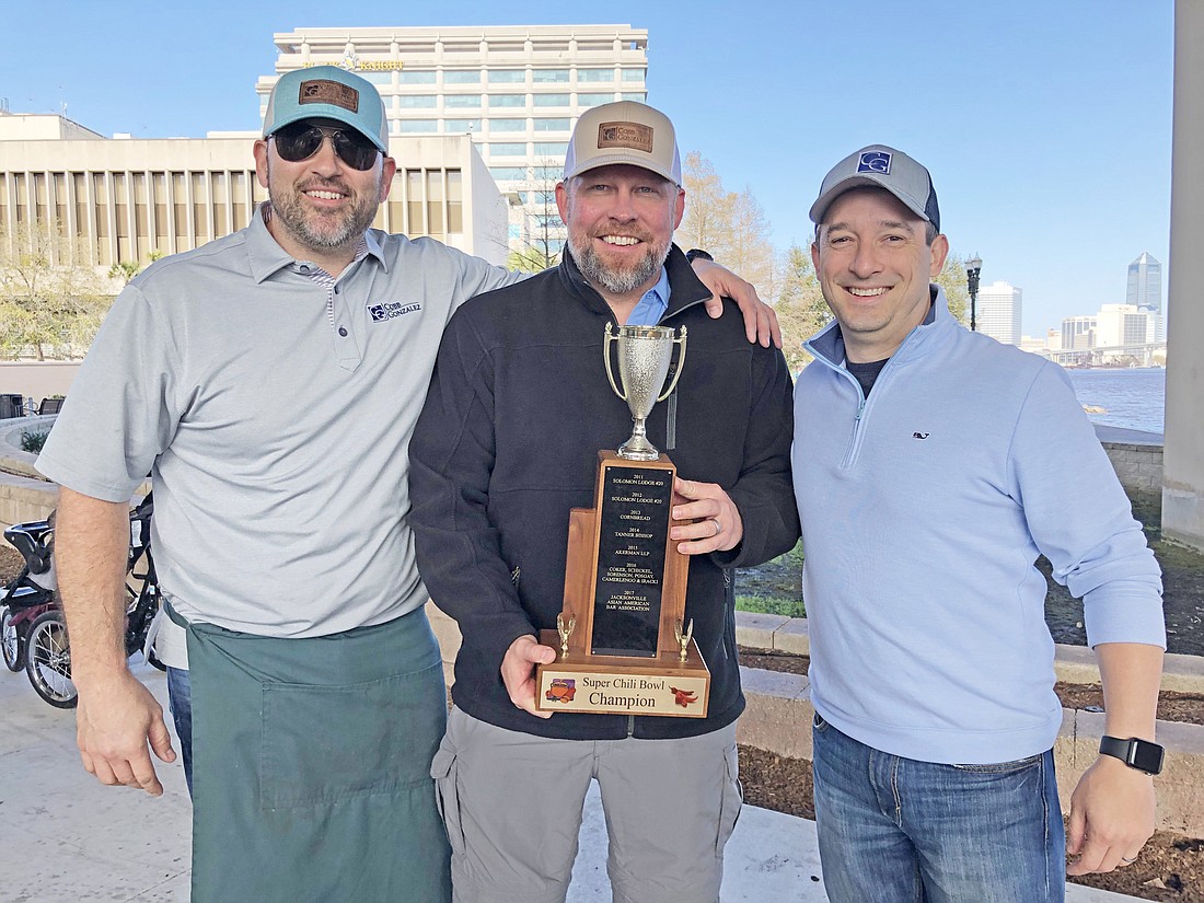 From left, James Gonzalez, Christopher Cobb and Nick Elder of the Cobb & Gonzalez law firm with their trophy for Best Overall Chili.