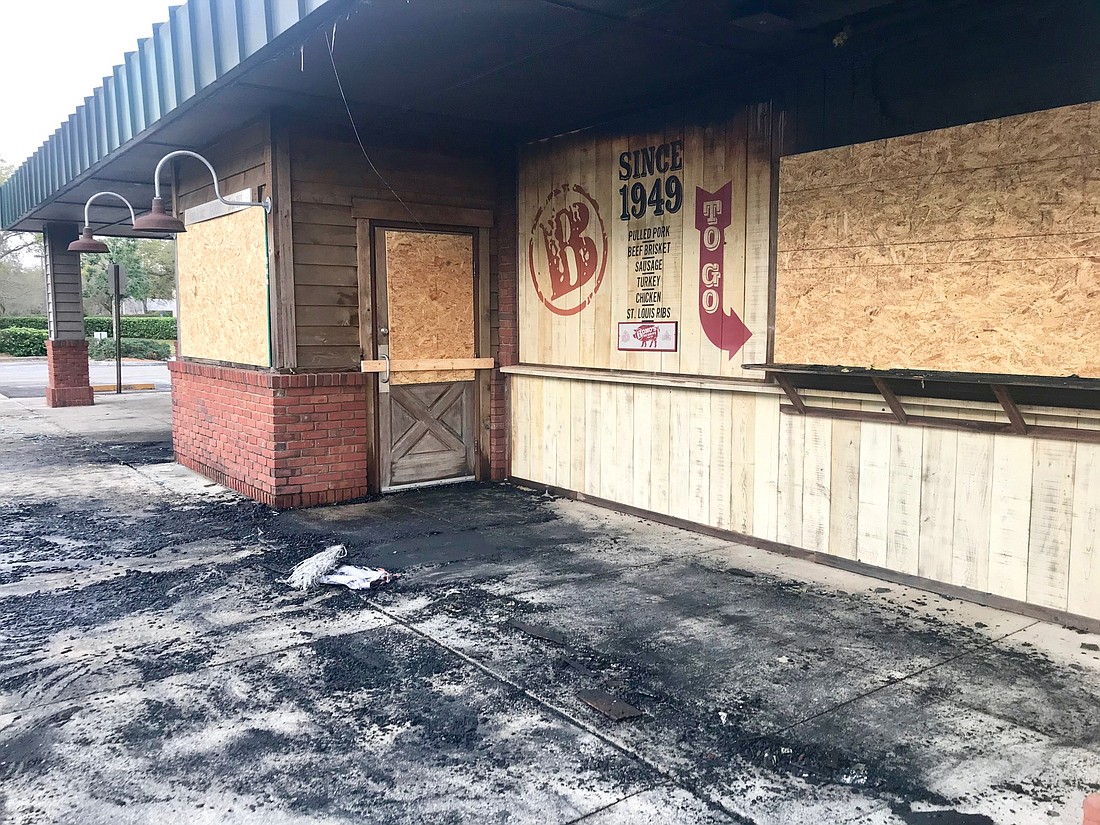 Windows were boarded up Tuesday morning following the Monday night fire at Bono&#39;s Pit Bar-B-Q on Gate Parkway.