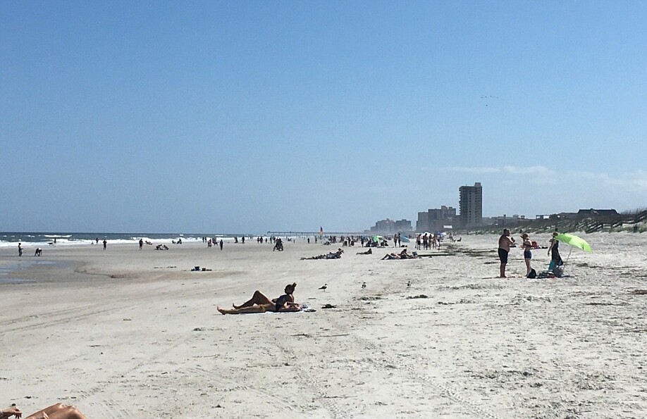 People enjoy Jacksonville Beach on March 20. Beginning at 5 p.m., the beach will be closed.