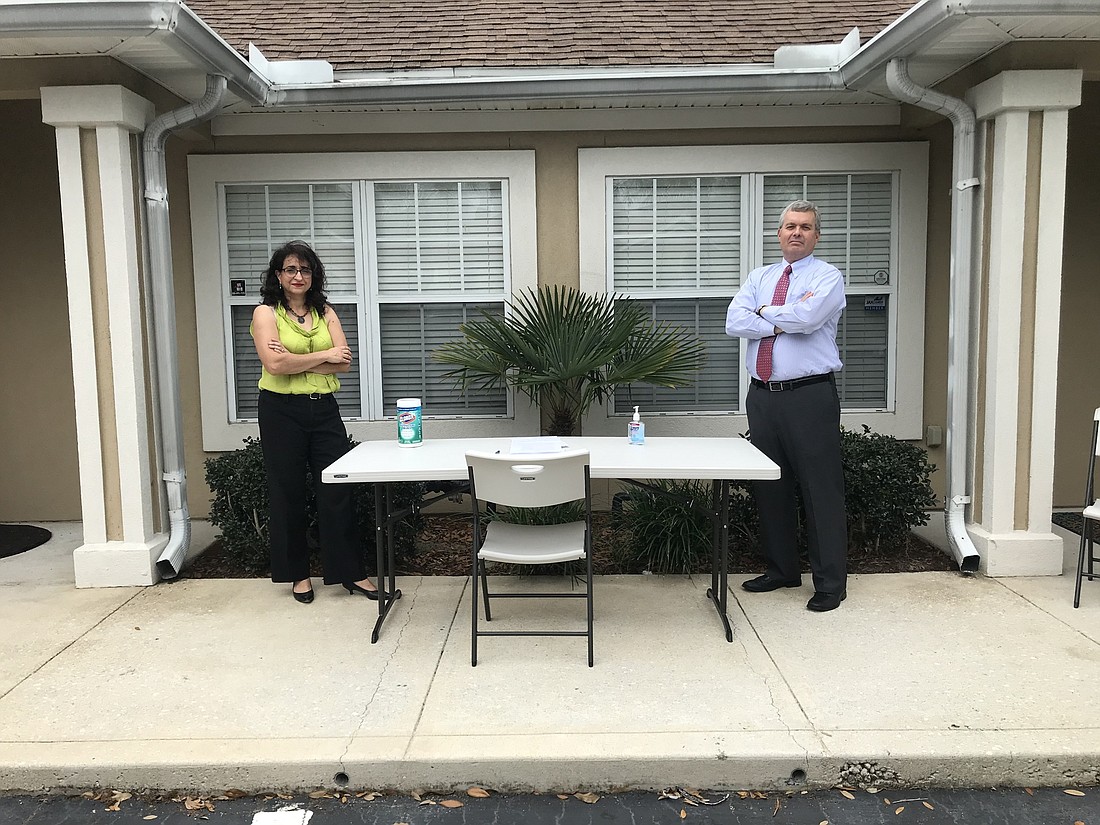 Attorney Rose Marie Preddy, founder of Preddy Law Firm, and Robert Perry Jr. with the Law Office of Robert Perry Jr. set up a table with hand sanitizer and other safety measures outside their officesÂ at 12627 San Jose Blvd.