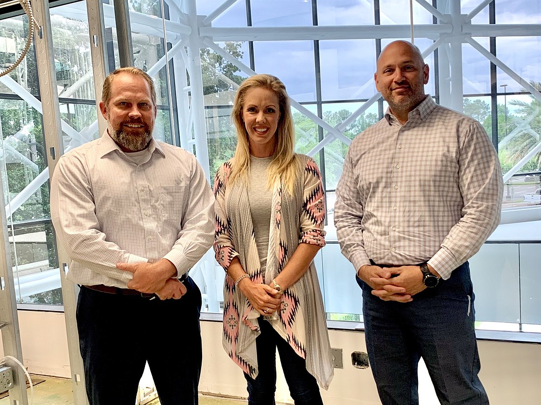 From left, attorney Christopher Cobb of Cobb & Gonzalez, Emerald Câ€™s Development Inc. President Brittany Culbreth and attorney James Gonzalez in the firmâ€™s new offices at The Quadrant II.