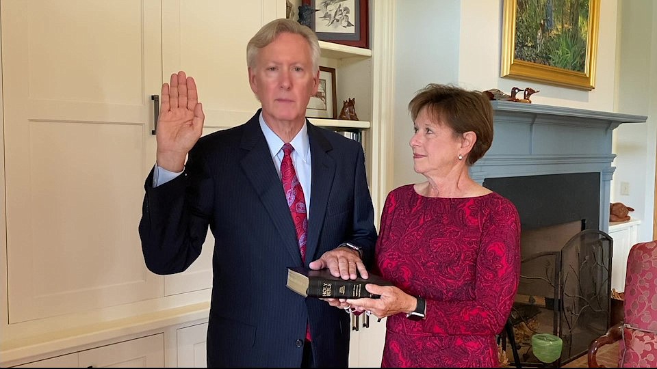 Michael TannerÂ is sworn in while his wife, Dawna, holds the Bible.