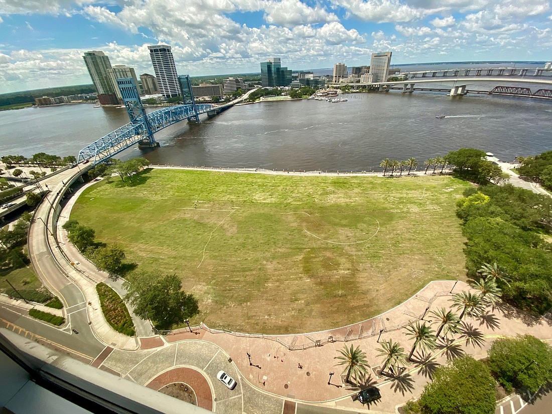 A lawn surrounded by a fence covers the former site of The Jacksonville Landing in Downtown Jacksonville.