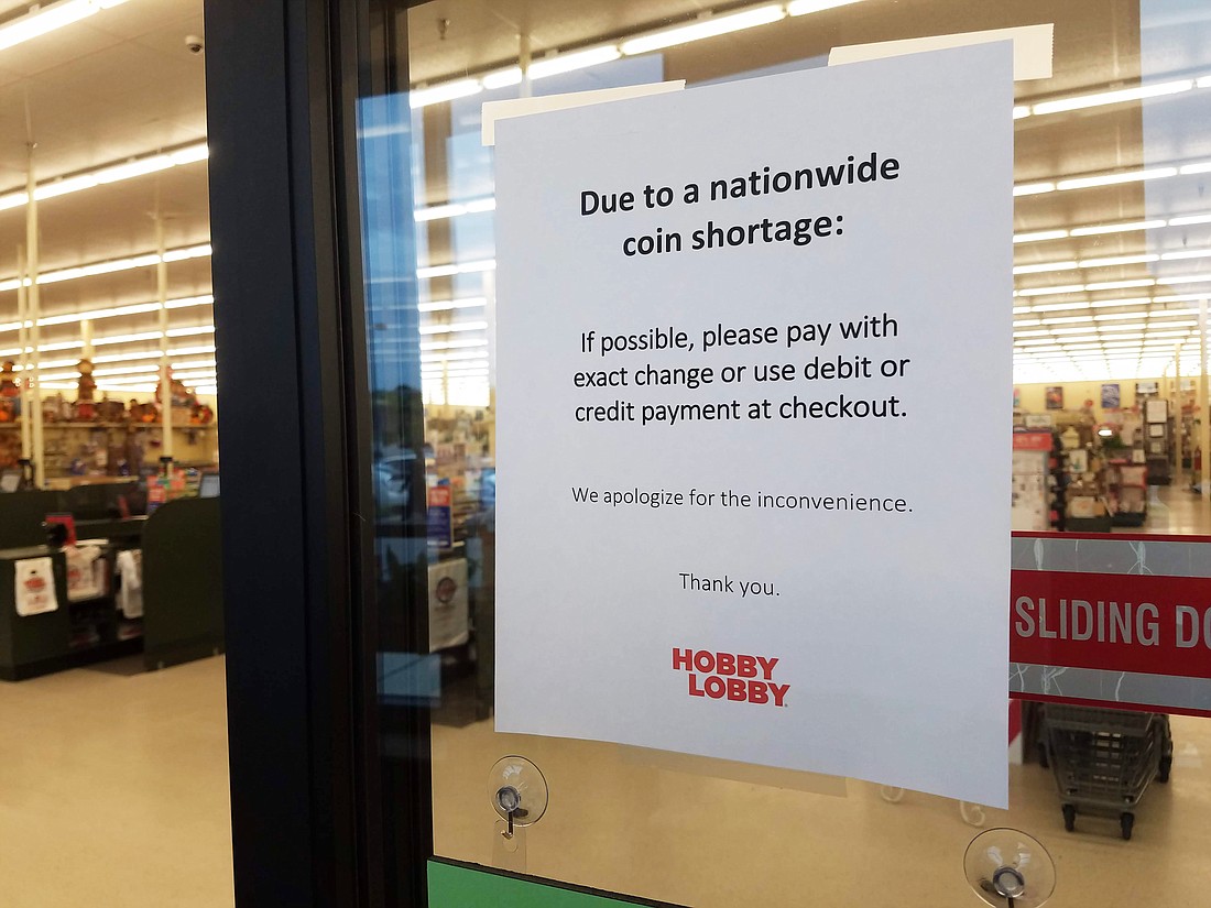 An appeal for exact change on the door to Hobby Lobby in North Jacksonville.
