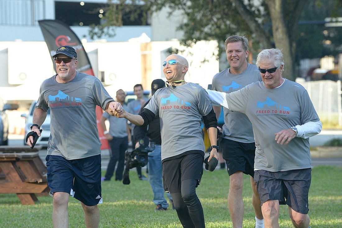 From left, Jacksonville Area Legal Aid CEO Jim Kowalski, Gunster shareholder Mike Freed, Circuit Judge Steven Fahlgren and retired Circuit Judge Hugh Carithers at the finish line of Freed to Run in 2019.