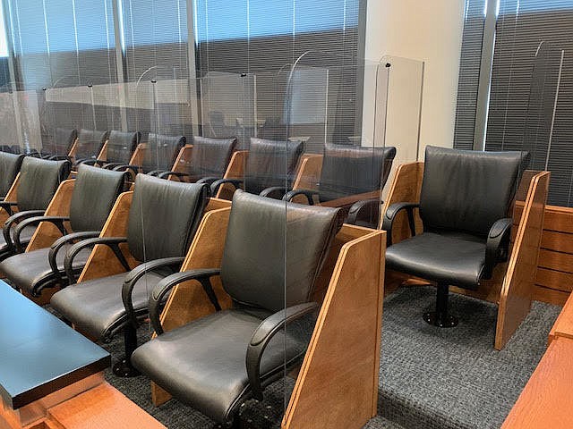 Clear plastic shields are installed between jurorsâ€™ seats in a courtroom at the Bryan Simpson U.S. Courthouse.