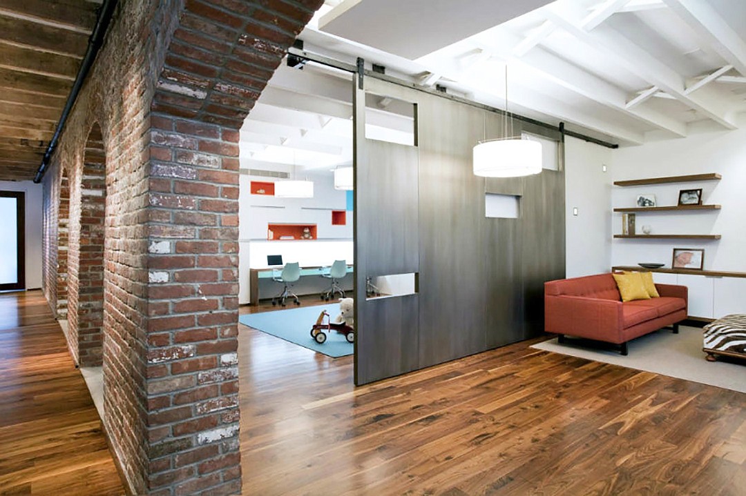 A sliding door can turn a room into a place for work, play or studying while preserving the flexibility of open space for gathering. (A+I Design Corp)