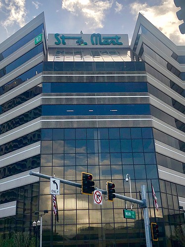 Workers remove the Stein Mart sign from the headquarters at 1200 Riverplace Blvd. the morning of Nov. 5.