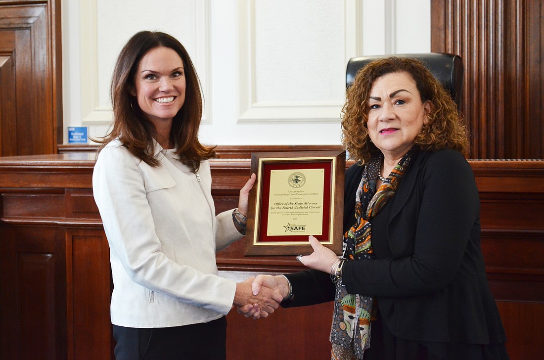State Attorney for the 4th Judicial Circuit Melissa Nelson, left, accepted the Outstanding Local Prosecutorâ€™s Office Award from Maria Chapa Lopez, U.S. Attorney for the Middle District of Florida.