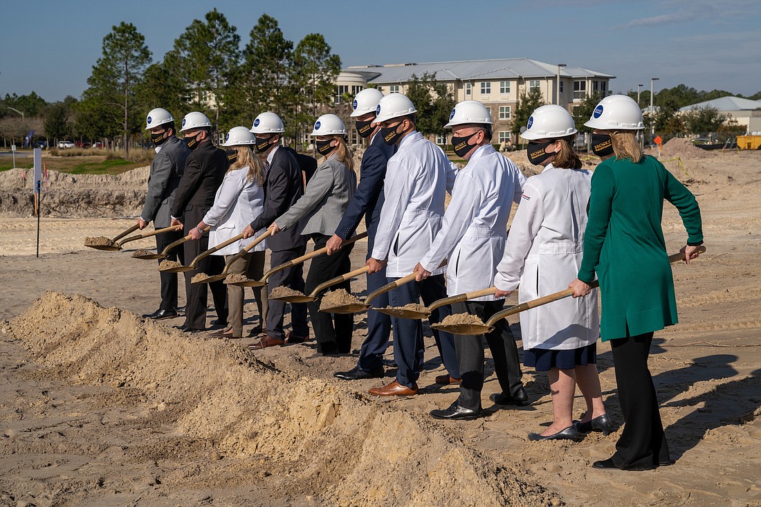 The ceremonial shovels of dirt are lifted at the ceremonial groundbreaking for the Brooks Rehabilitation hospital Jan. 25.